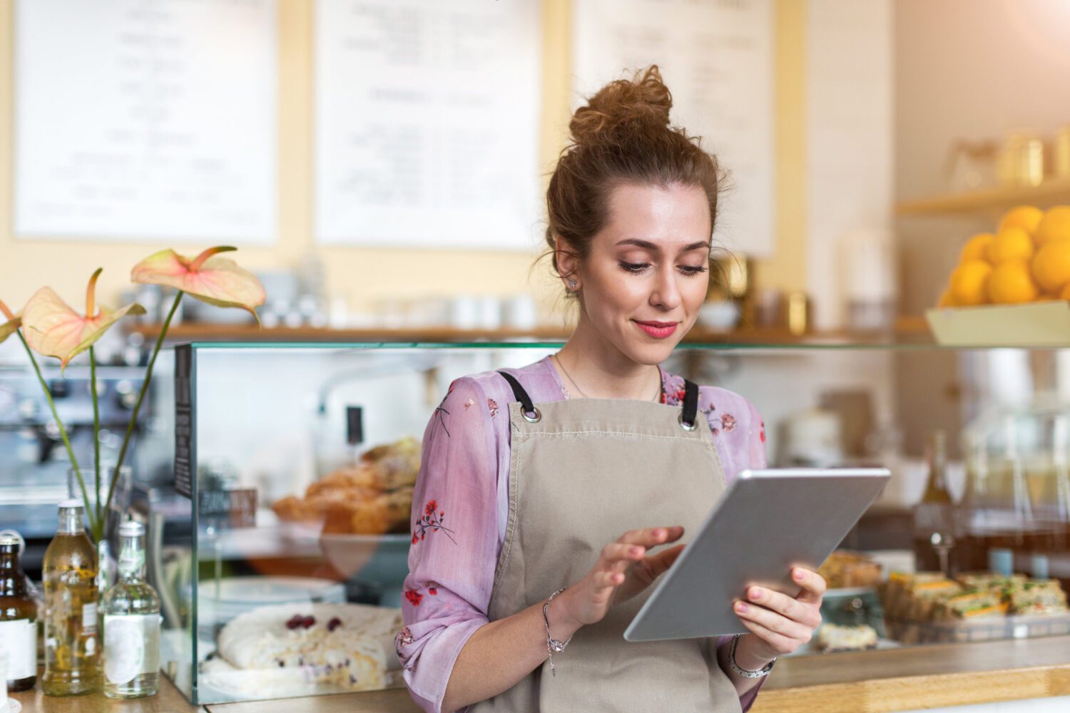 Young woman using a digital tablet in a coffee shop