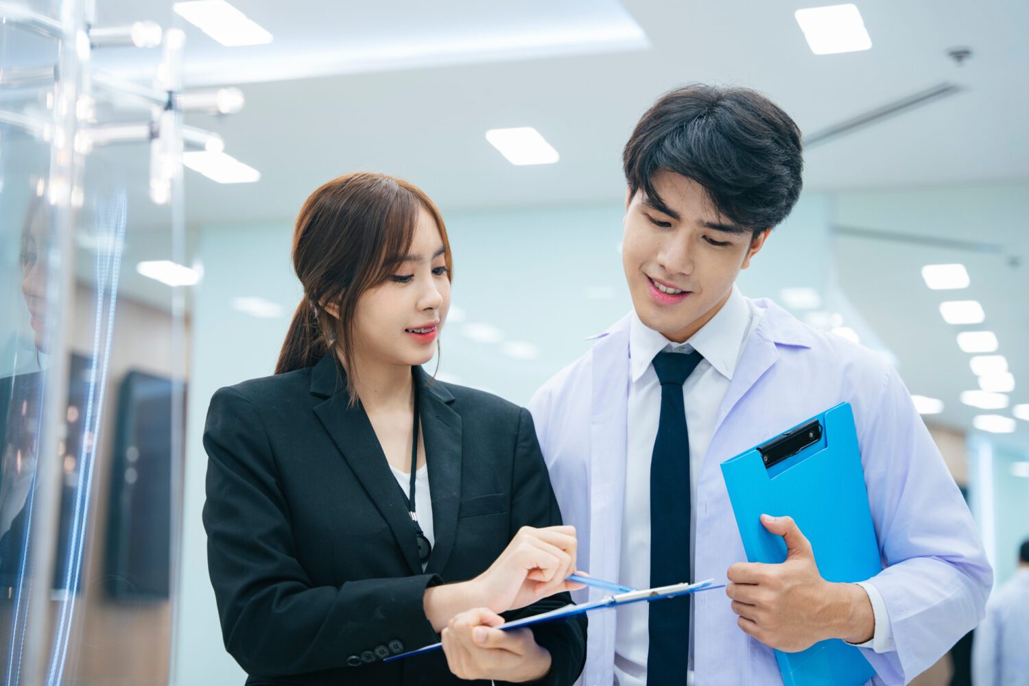Asian doctor and beautiful secertary working together in hospita